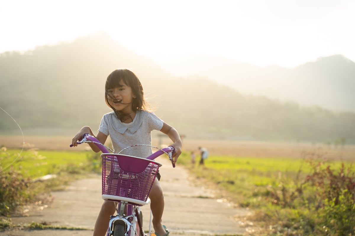 Independent Asian Child Ride Her Bicycle